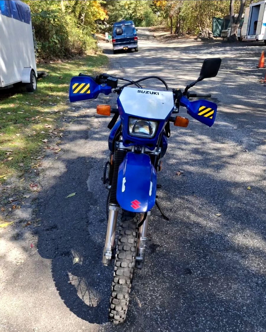A blue dual-sport motorcycle on a road near Walden, New York.