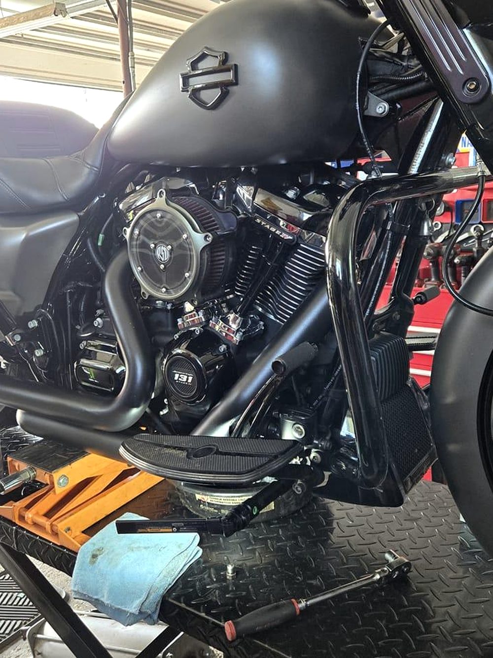 A Harley-Davidson engine and a helmet on the lift at Blackwood Cycles in Walden, New York.